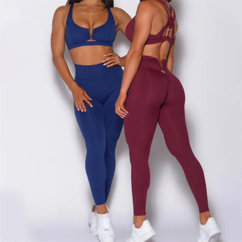 Two people wearing blue and maroon athletic outfits on a white background