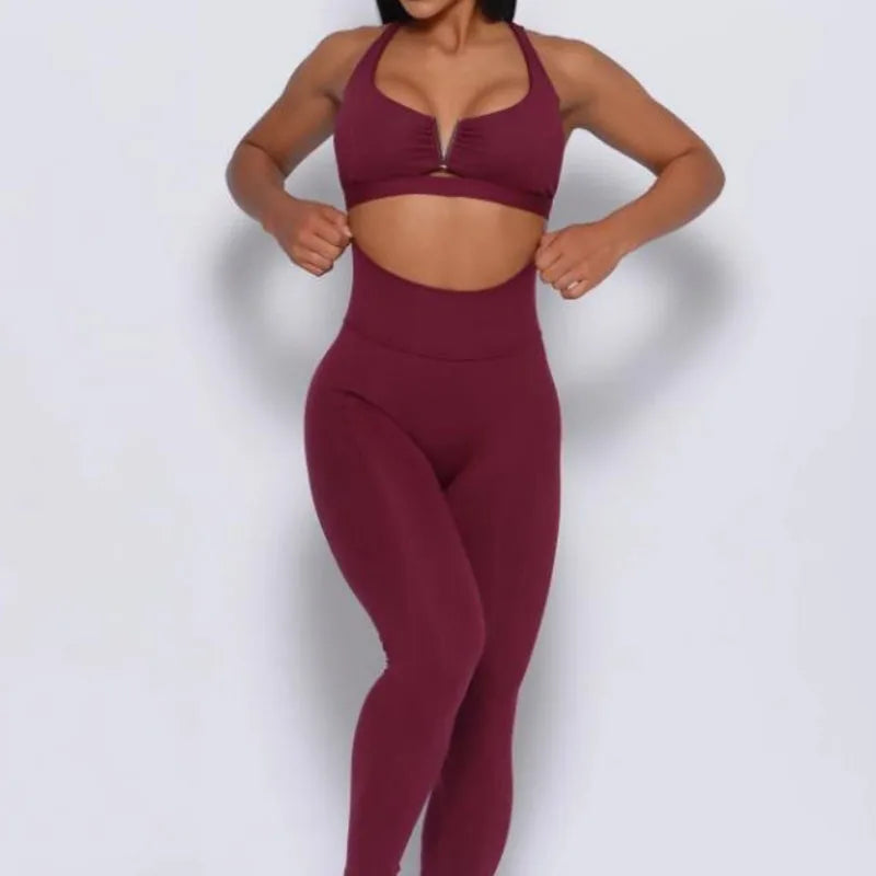 Maroon sports bra and leggings set on a white background