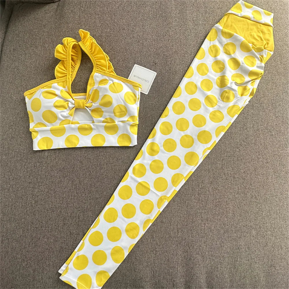 Yellow and white polka dot bikini set on a brown surface