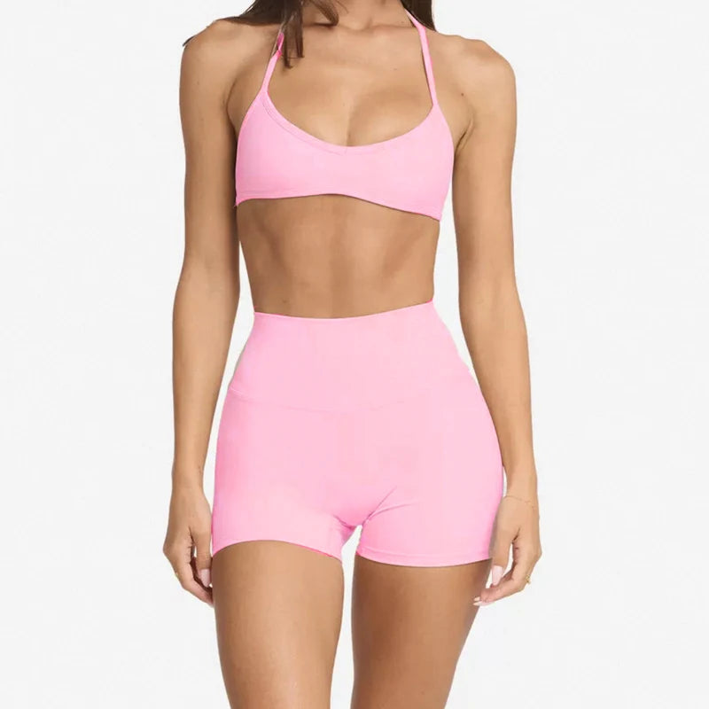 woman wearing a halter neck bra top and shorts gym set