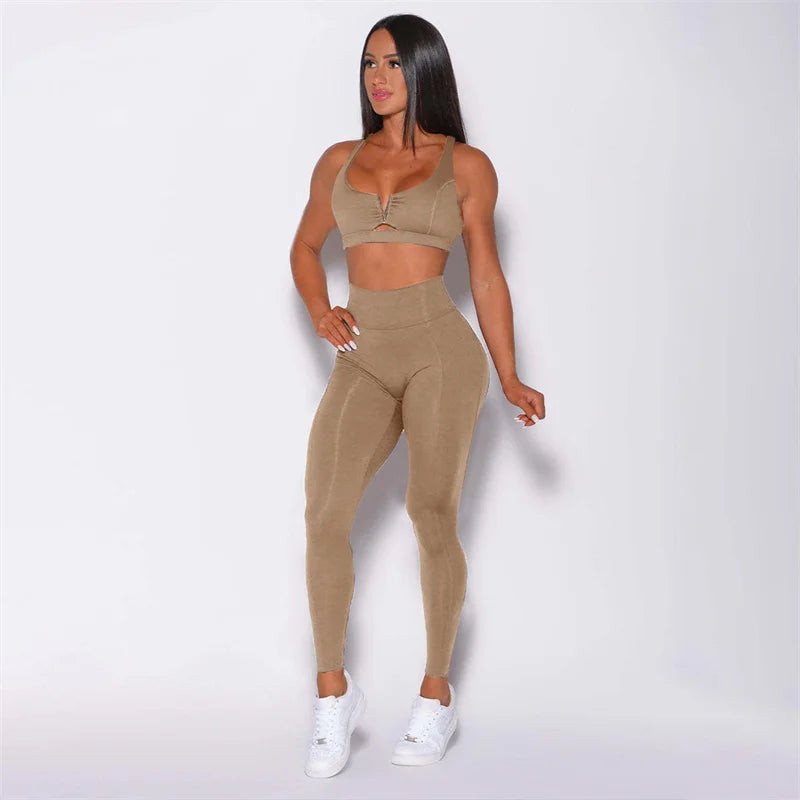 Woman wearing a beige matching set with white sneakers on a light gray background