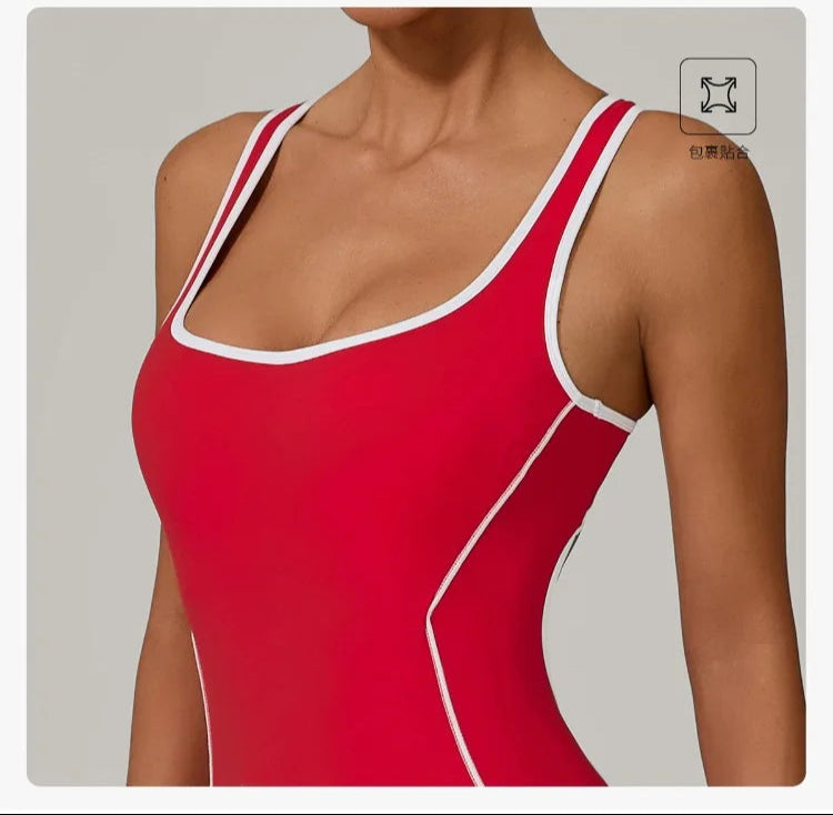 Red jumpsuit with white trim worn by a model on a gray background