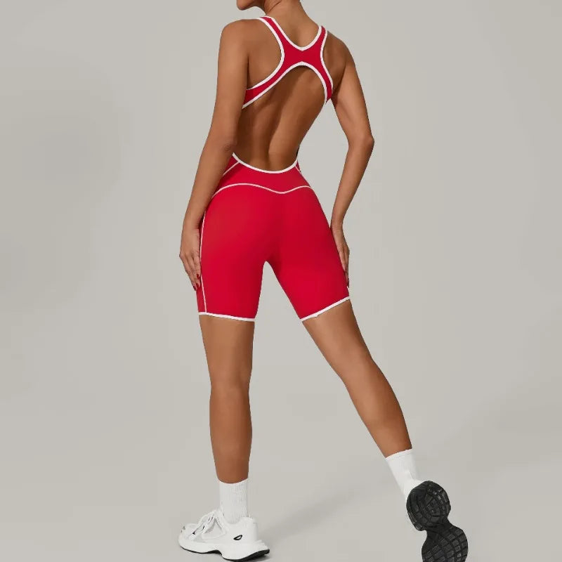 Person wearing a red athletic outfit with white accents on a gray background