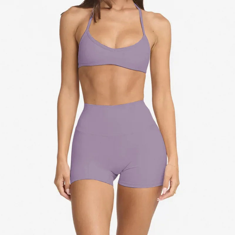 woman wearing a halter neck bra top and shorts gym set